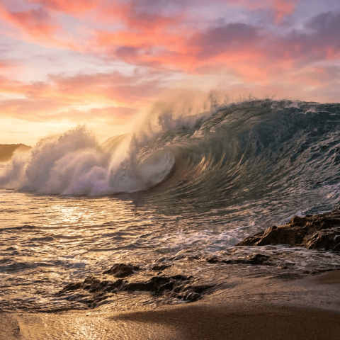 Breathtaking Ocean Wave Crashing at Sunrise with Golden Shimmer