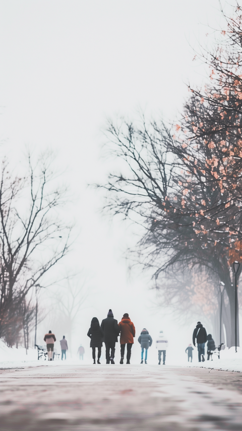 People Walking Through a Foggy Winter Park